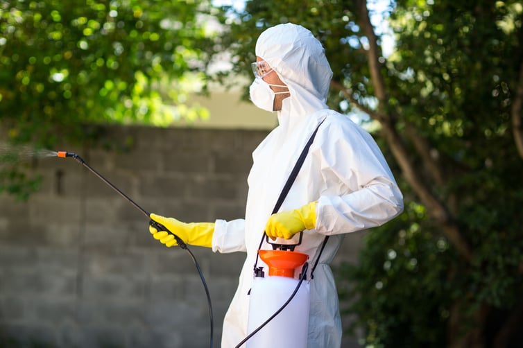 side-view-worker-using-pesticide-back-yard